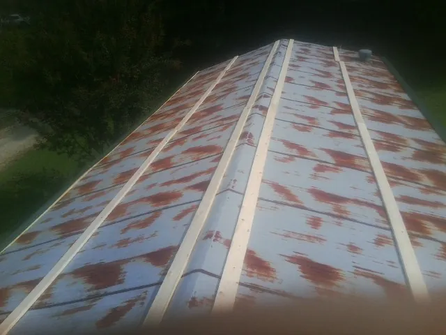 Rusted metal roof panels with new wood purlins before replacement — Storm Damage Roof Repair in Chesterfield by Roofing Brothers